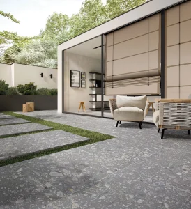 Grey terrazzo concrete outdoor terrace beside a contemporary house